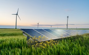 Photovoltaik-Anlage auf Agrarfläche mit Windkraftanlagen im Hintergrund Photovoltaik-Anlage auf Agrarfläche mit Windkraftanlagen im Hintergrund